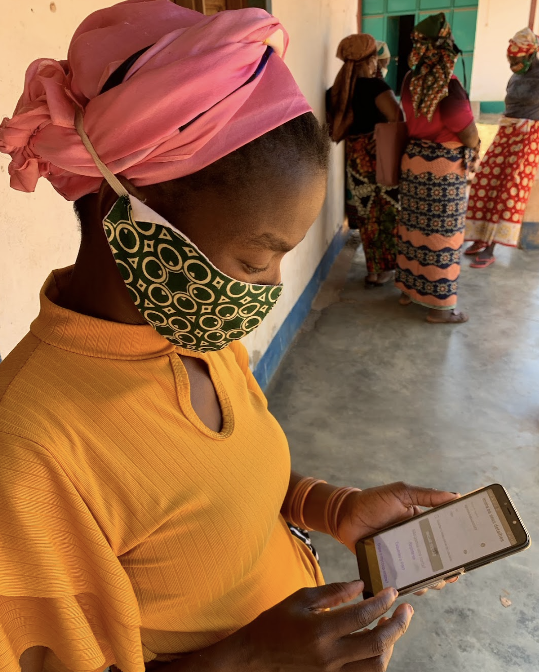 A farmer using the hiveonline app on her cellphone